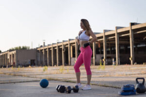 Young athlete is preparing for a workout in abandoned factory